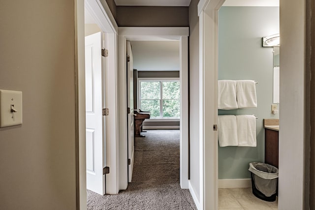 hall featuring light colored carpet