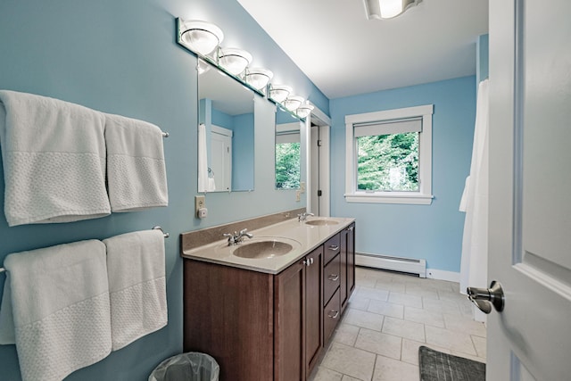 bathroom featuring tile patterned flooring, vanity, and a baseboard heating unit