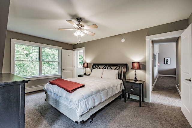 carpeted bedroom featuring ceiling fan and a baseboard radiator