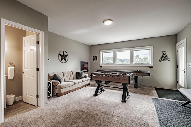 recreation room featuring light colored carpet