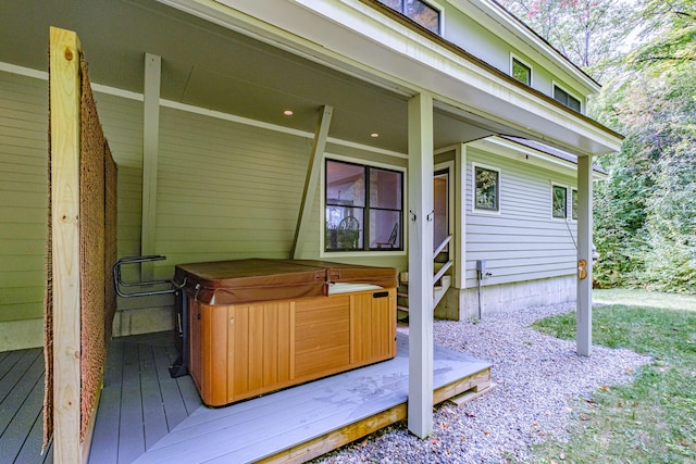 wooden deck featuring a hot tub