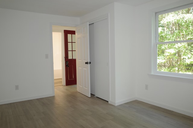 spare room with light hardwood / wood-style flooring and a healthy amount of sunlight