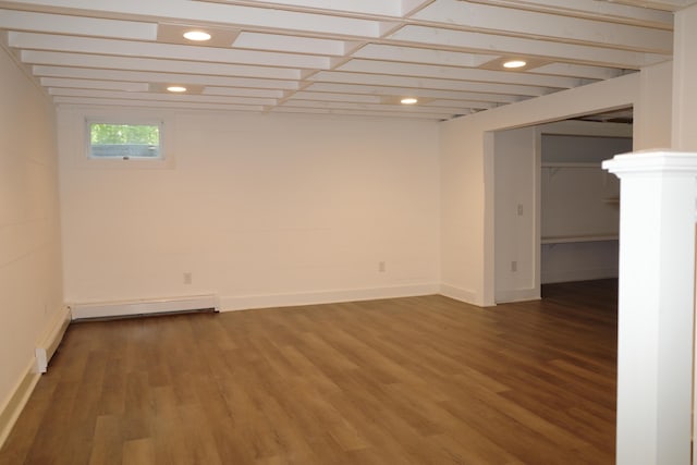 basement featuring hardwood / wood-style flooring and a baseboard heating unit