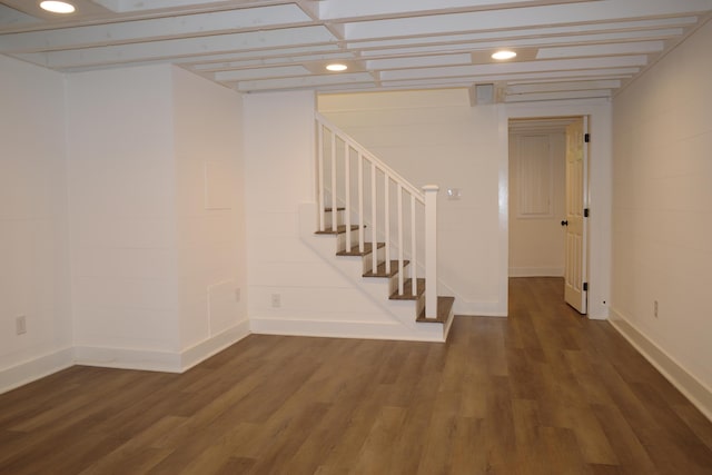 basement with dark hardwood / wood-style flooring