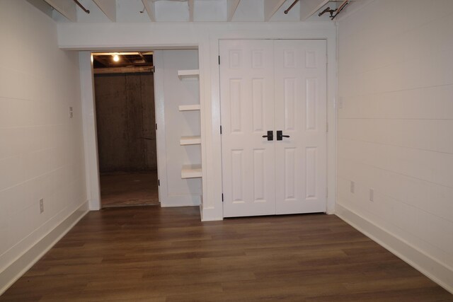 unfurnished bedroom with dark wood-type flooring