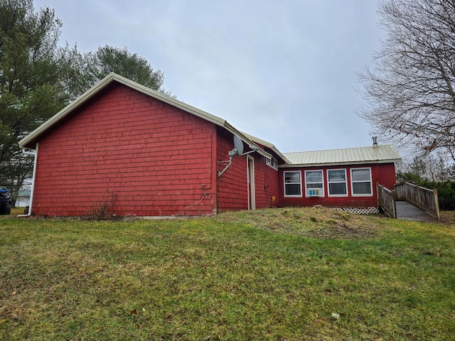 view of property exterior featuring a lawn