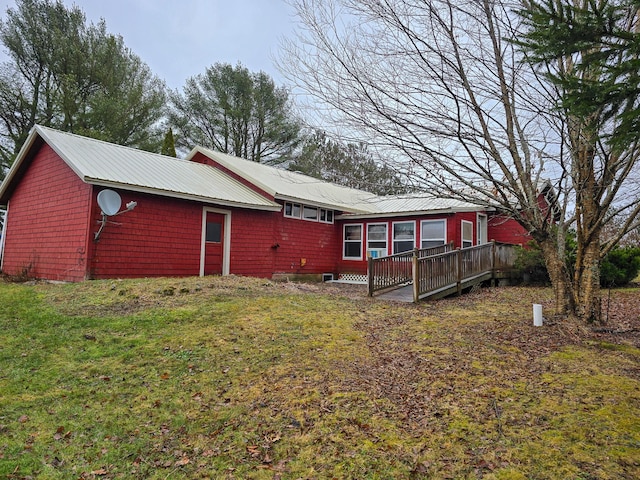 rear view of house with a yard and a wooden deck