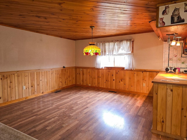 unfurnished dining area featuring dark hardwood / wood-style flooring and wooden ceiling