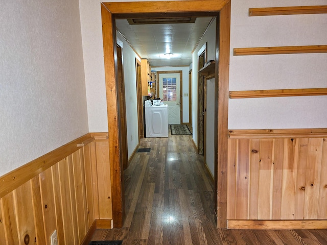 hall with washer / dryer and dark wood-type flooring