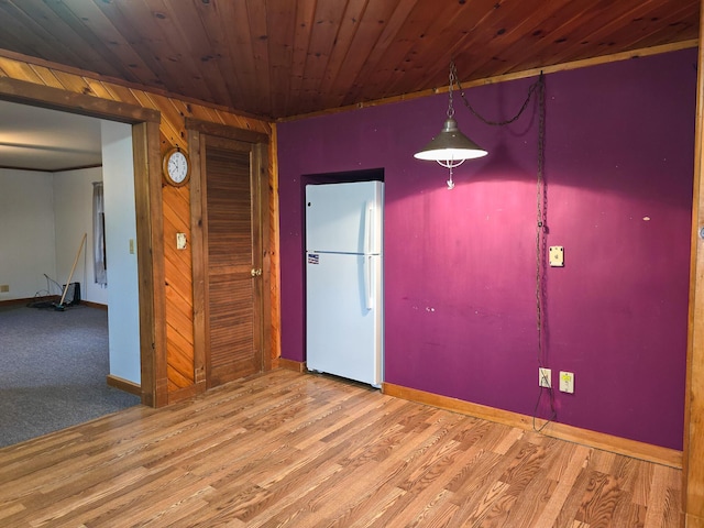 empty room featuring wood ceiling and wood-type flooring