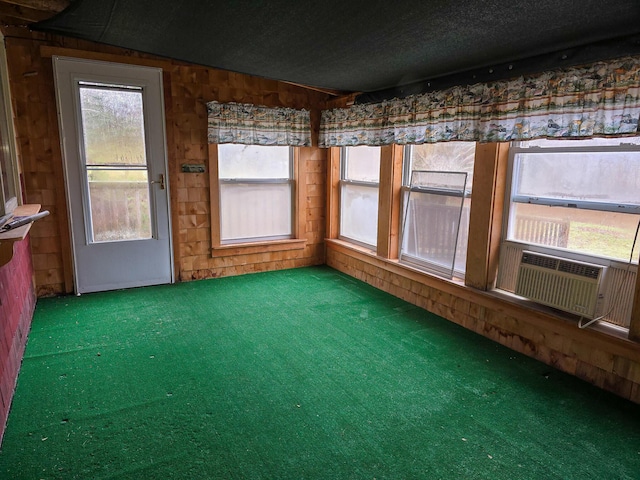 unfurnished sunroom featuring cooling unit and lofted ceiling