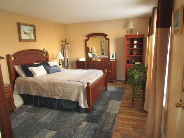 bedroom with dark wood-type flooring