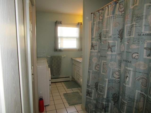 bathroom with tile patterned floors, vanity, a baseboard radiator, and washer / dryer