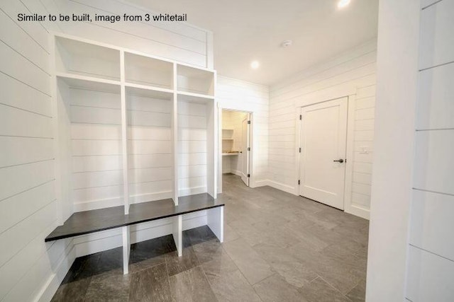 mudroom with wood walls