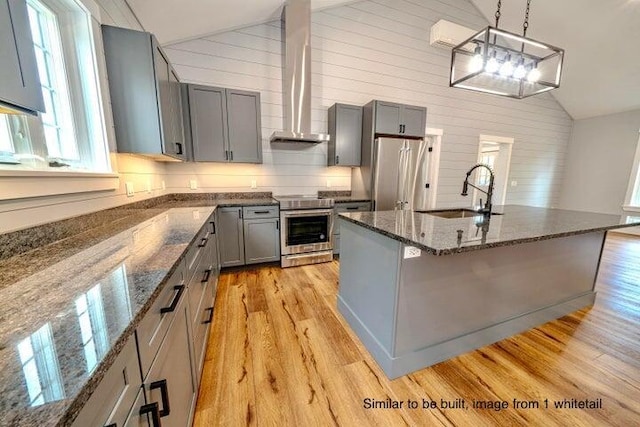 kitchen featuring stainless steel appliances, vaulted ceiling, pendant lighting, and sink