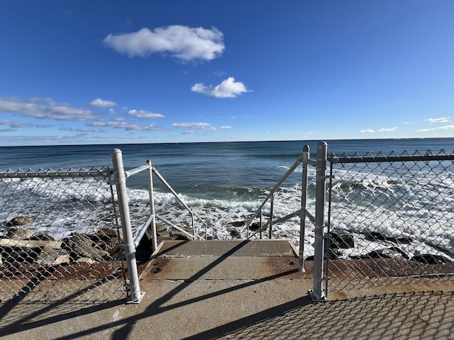 view of community featuring a beach view and a water view