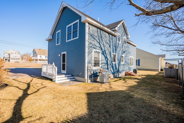 rear view of property with a yard