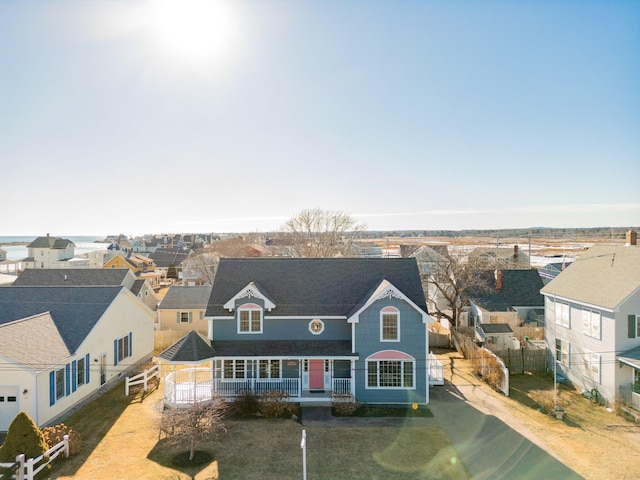 cape cod home featuring a porch