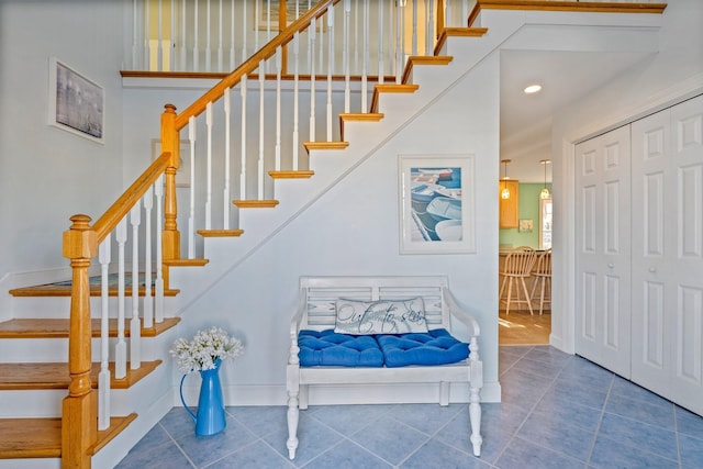 staircase featuring tile patterned flooring