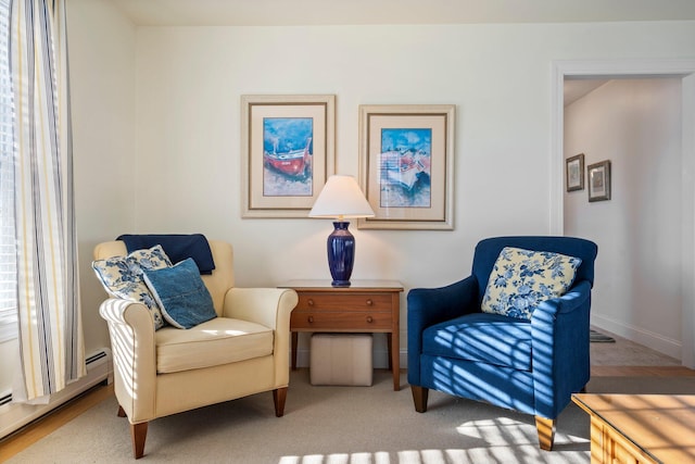 sitting room with a baseboard heating unit