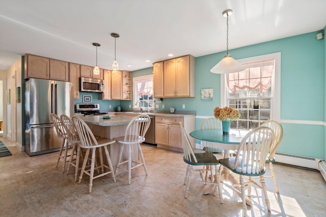 kitchen featuring hanging light fixtures, stainless steel appliances, light brown cabinetry, a kitchen island, and sink