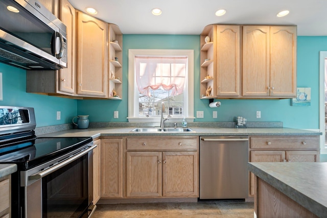 kitchen with stainless steel appliances, light brown cabinets, and sink