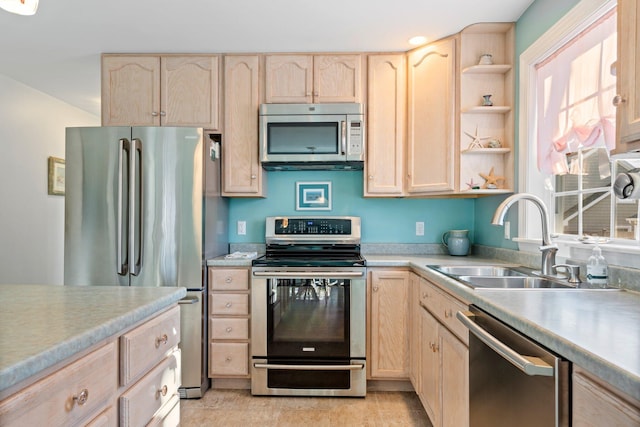 kitchen with sink, stainless steel appliances, and light brown cabinets