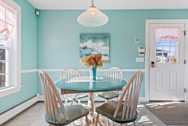 dining area featuring a baseboard radiator and a healthy amount of sunlight