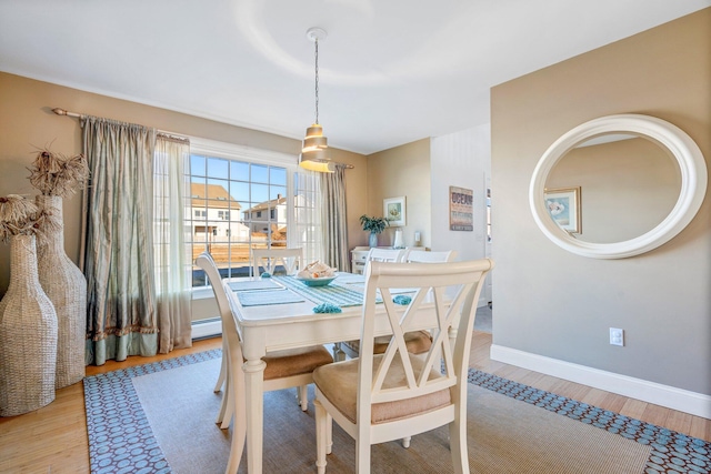 dining area with light hardwood / wood-style floors and baseboard heating