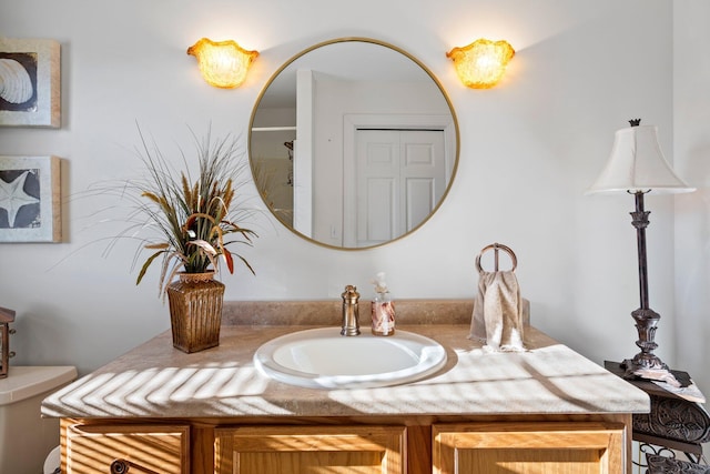 bathroom featuring toilet and vanity