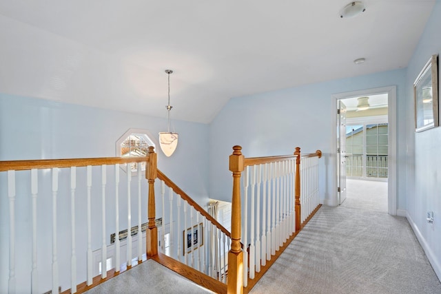 corridor featuring light carpet and lofted ceiling