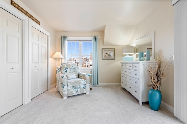 sitting room featuring light colored carpet and vaulted ceiling