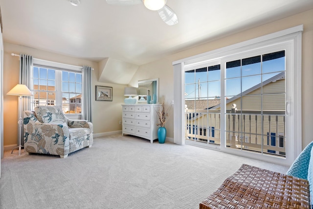 sitting room with ceiling fan, light carpet, and lofted ceiling