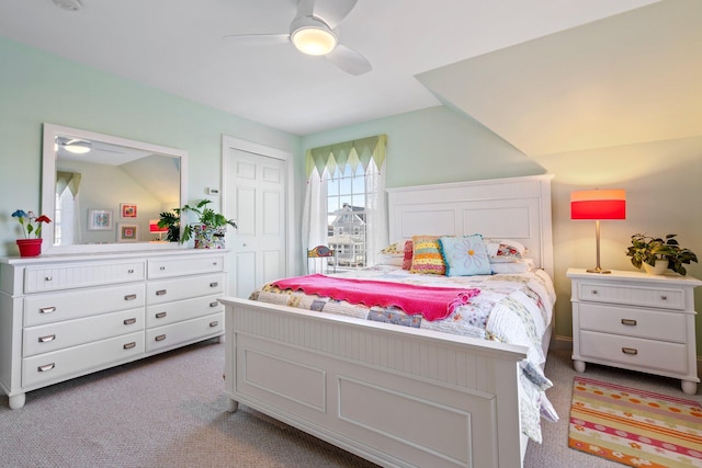 carpeted bedroom featuring a closet and ceiling fan