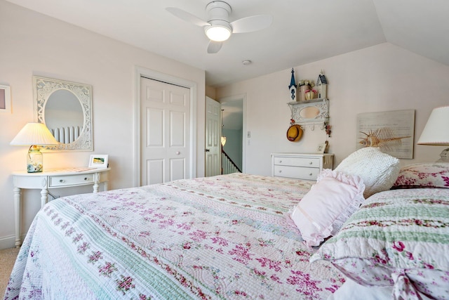 bedroom with ceiling fan, a closet, and vaulted ceiling