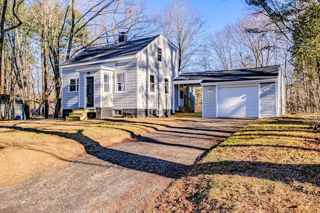 view of front of house with a garage and a front lawn