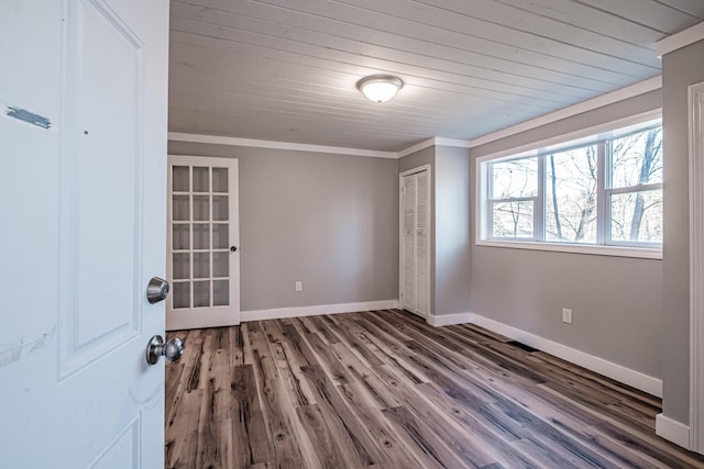 spare room with wood ceiling, crown molding, and dark wood-type flooring