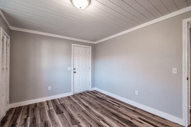 spare room with hardwood / wood-style floors, crown molding, and wood ceiling