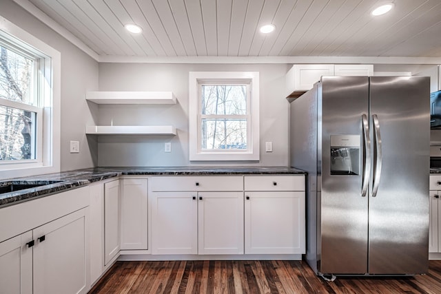 kitchen featuring white cabinets, stainless steel refrigerator with ice dispenser, and plenty of natural light