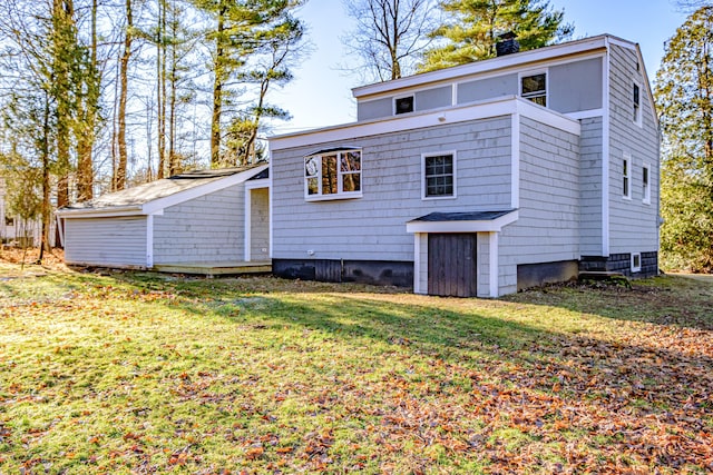 rear view of house featuring a yard