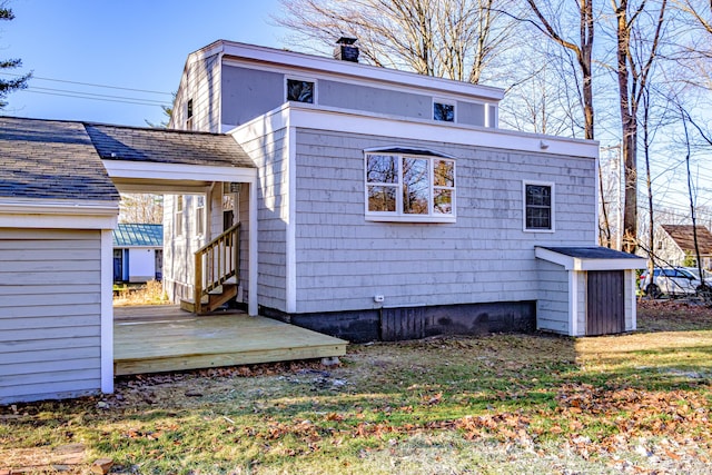 rear view of house with a wooden deck