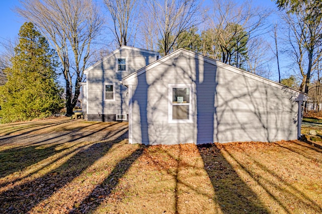 view of property exterior with a lawn