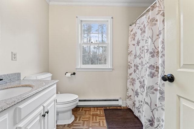 bathroom with parquet flooring, vanity, crown molding, a baseboard heating unit, and toilet