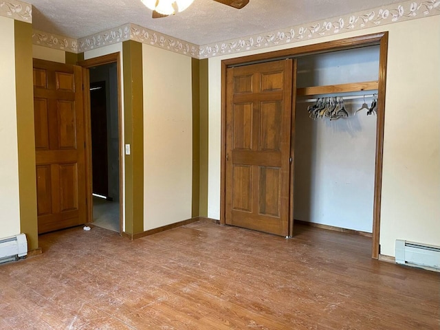 unfurnished bedroom with ceiling fan, a closet, wood-type flooring, and a textured ceiling