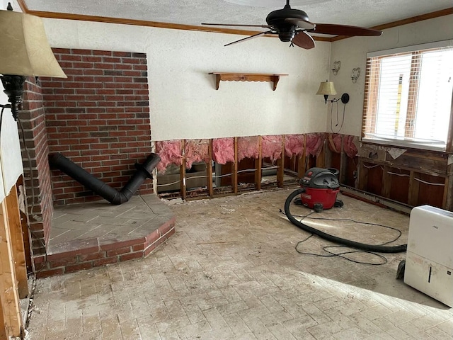 interior space featuring ceiling fan, crown molding, and a textured ceiling