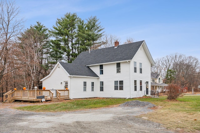 back of house with a yard and a wooden deck