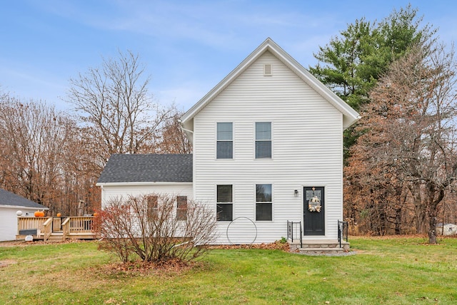 back of house with a lawn and a wooden deck