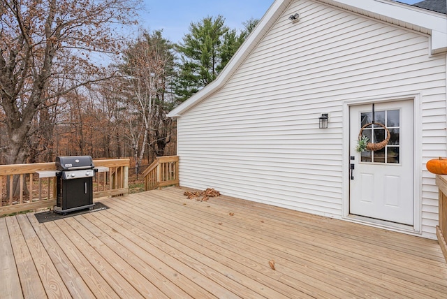 wooden deck featuring a grill