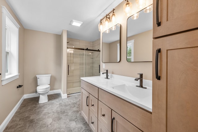 bathroom featuring vanity, an enclosed shower, and toilet