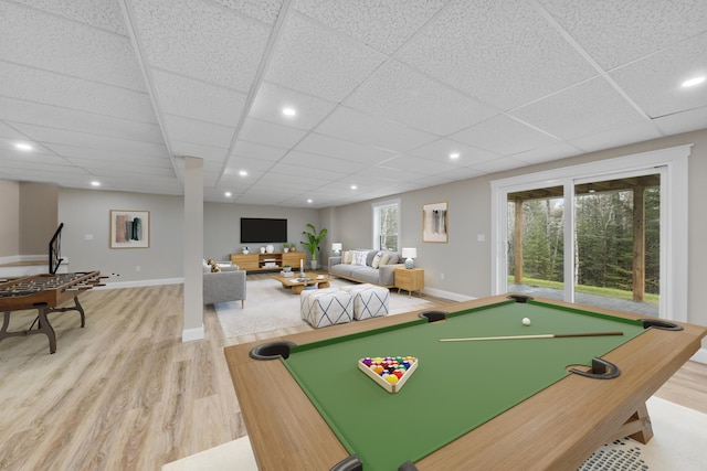 game room with a drop ceiling, pool table, and light hardwood / wood-style flooring